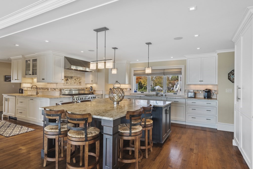 15 Spray Avenue Marblehead, MA 01945 - Photo 18 of 42 a kitchen with stainless steel appliances kitchen island granite countertop a table chairs and a stove