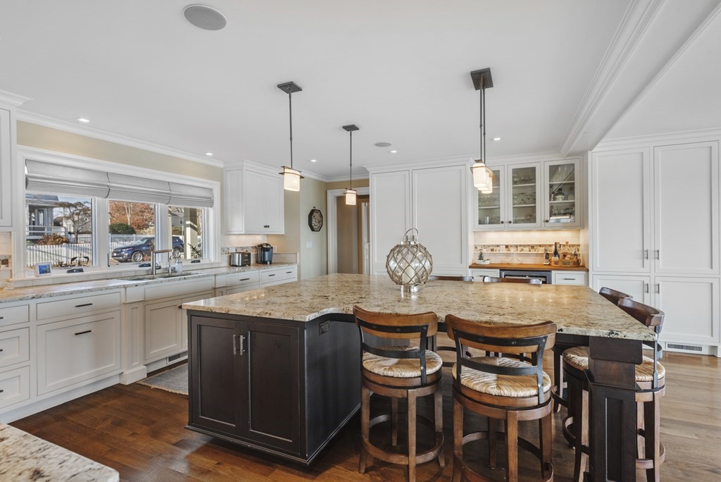 15 Spray Avenue Marblehead, MA 01945 - Photo 20 of 42 a kitchen with granite countertop a table chairs stove and cabinets