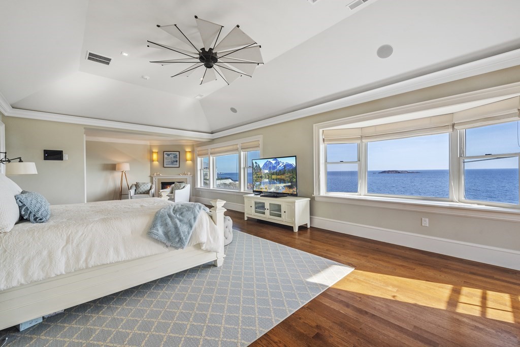 15 Spray Avenue Marblehead, MA 01945 - Photo 29 of 42 a spacious bedroom with a large bed and a chandelier