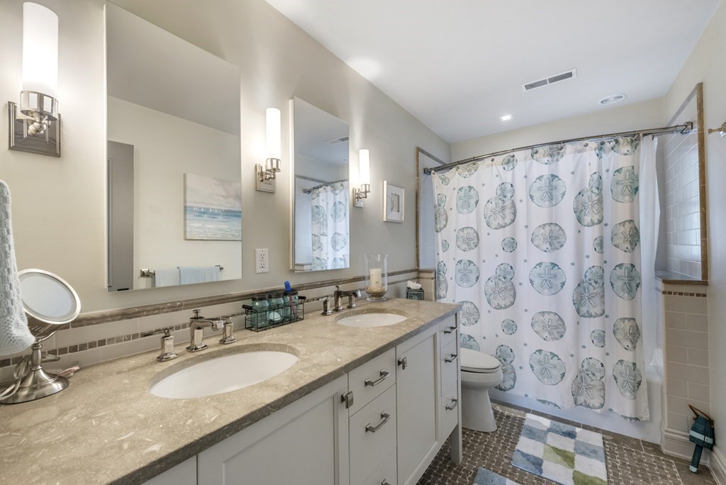 15 Spray Avenue Marblehead, MA 01945 - Photo 34 of 42 a bathroom with double vanity sink and a mirror