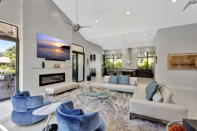 a living room with furniture and a floor to ceiling window
