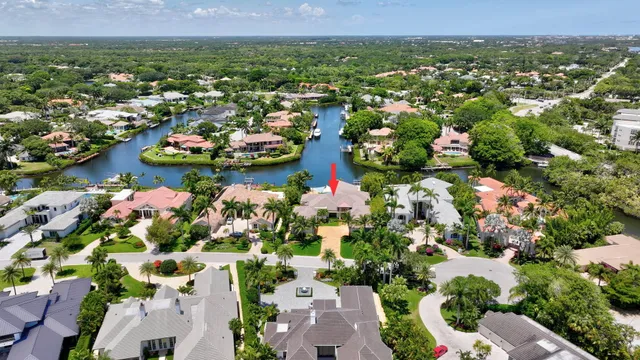 an aerial view of residential houses with outdoor space and lake view