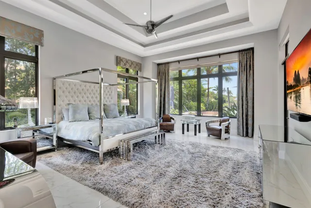 a bedroom with furniture and a flat screen tv