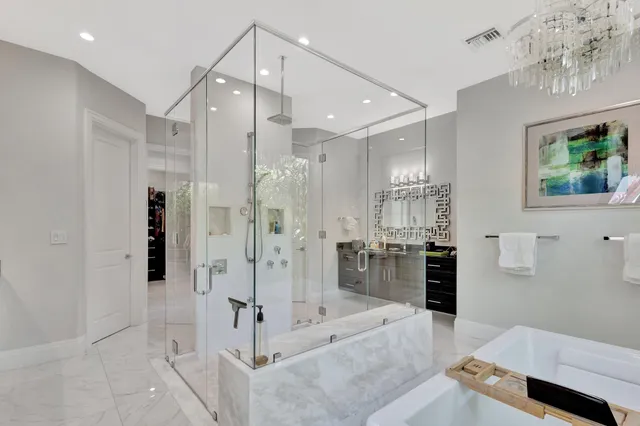 a bathroom with a double vanity sink mirror and shower