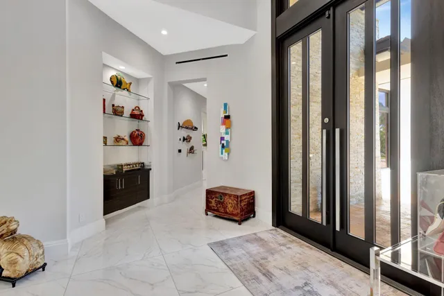 a living room with furniture a large window and a table