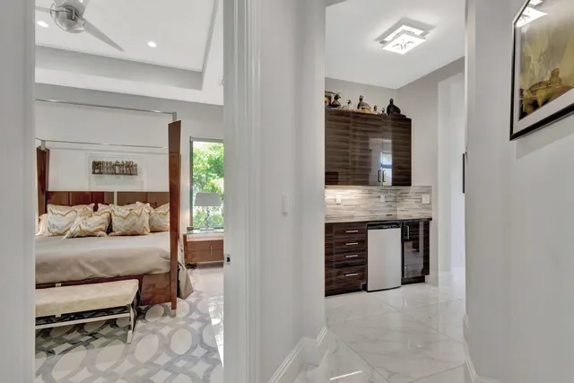a view of a livingroom with furniture and floor to ceiling window