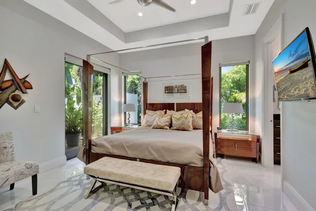 a view of a patio with a table and chairs under an umbrella