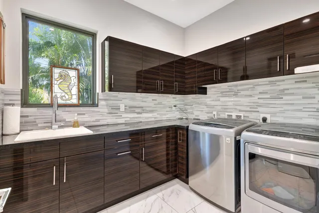a view of a deck with a table and chairs next to a yard