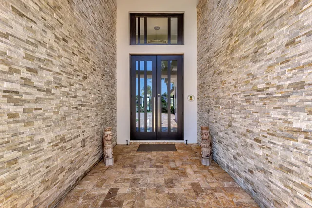 a living room with furniture kitchen view and a large window