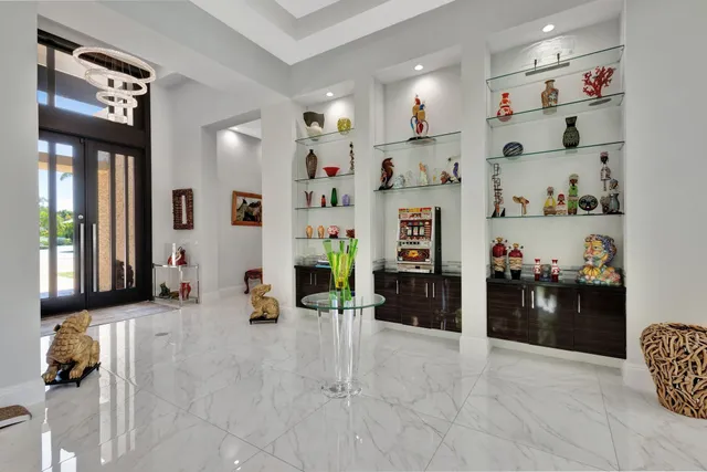 a kitchen with stainless steel appliances granite countertop a table and chairs in it