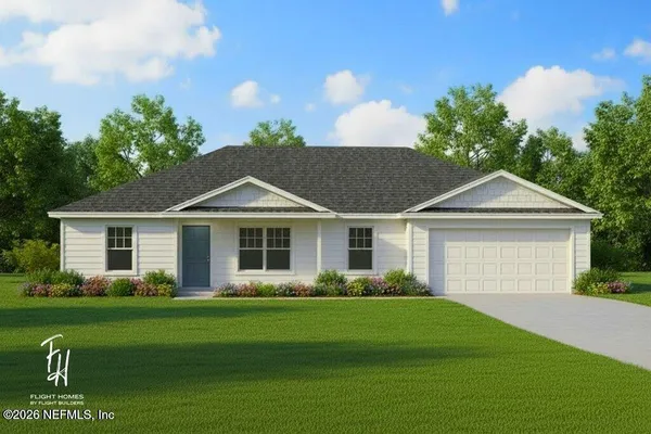 a front view of a house with a garden and yard