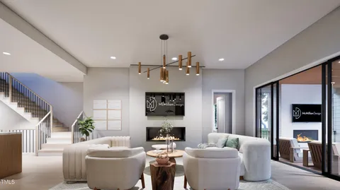 a living room with furniture a fireplace and a chandelier