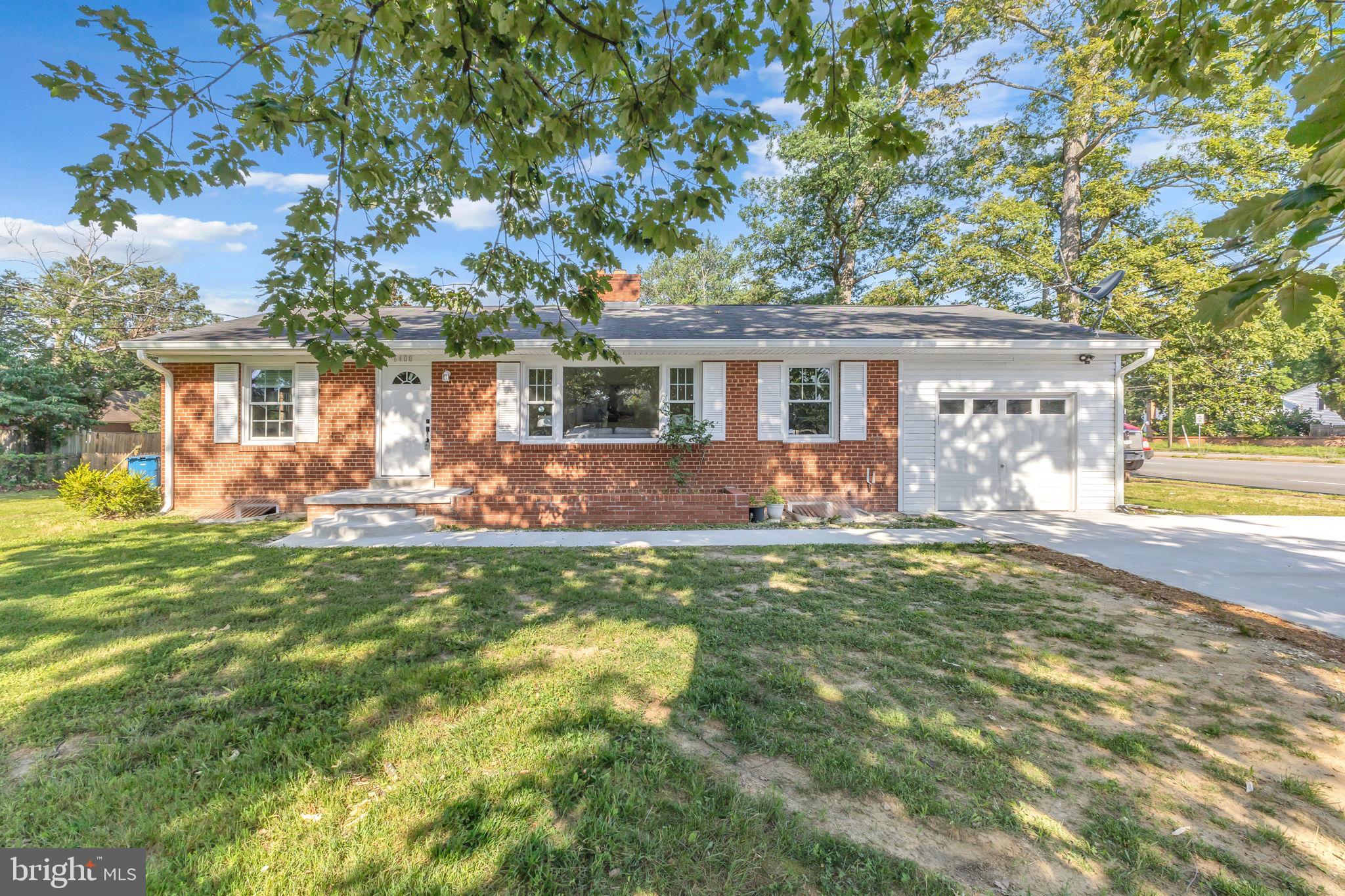 a front view of house with yard and outdoor seating