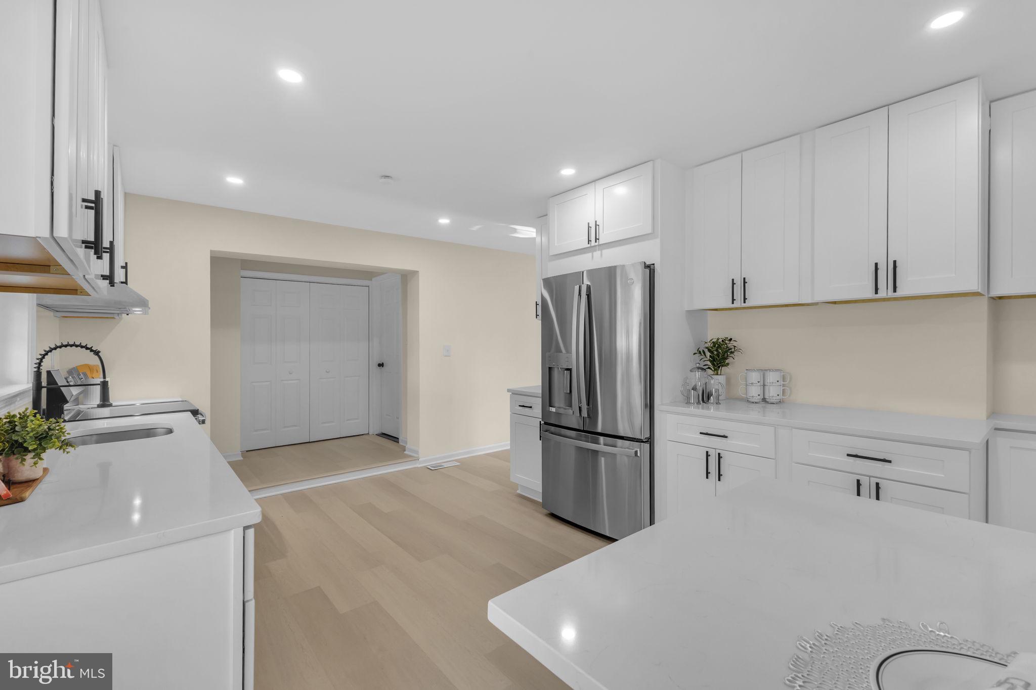 6400 Inwood Drive Springfield, VA 22150 - Photo 11 of 37 a kitchen with a refrigerator sink and cabinets