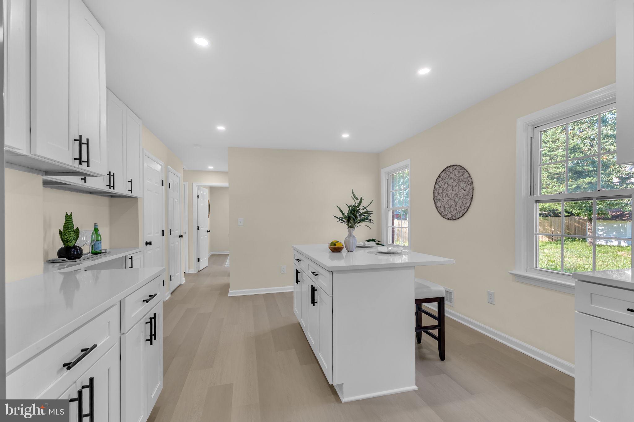6400 Inwood Drive Springfield, VA 22150 - Photo 12 of 37 a large kitchen with stainless steel appliances a lot of counter space and a window
