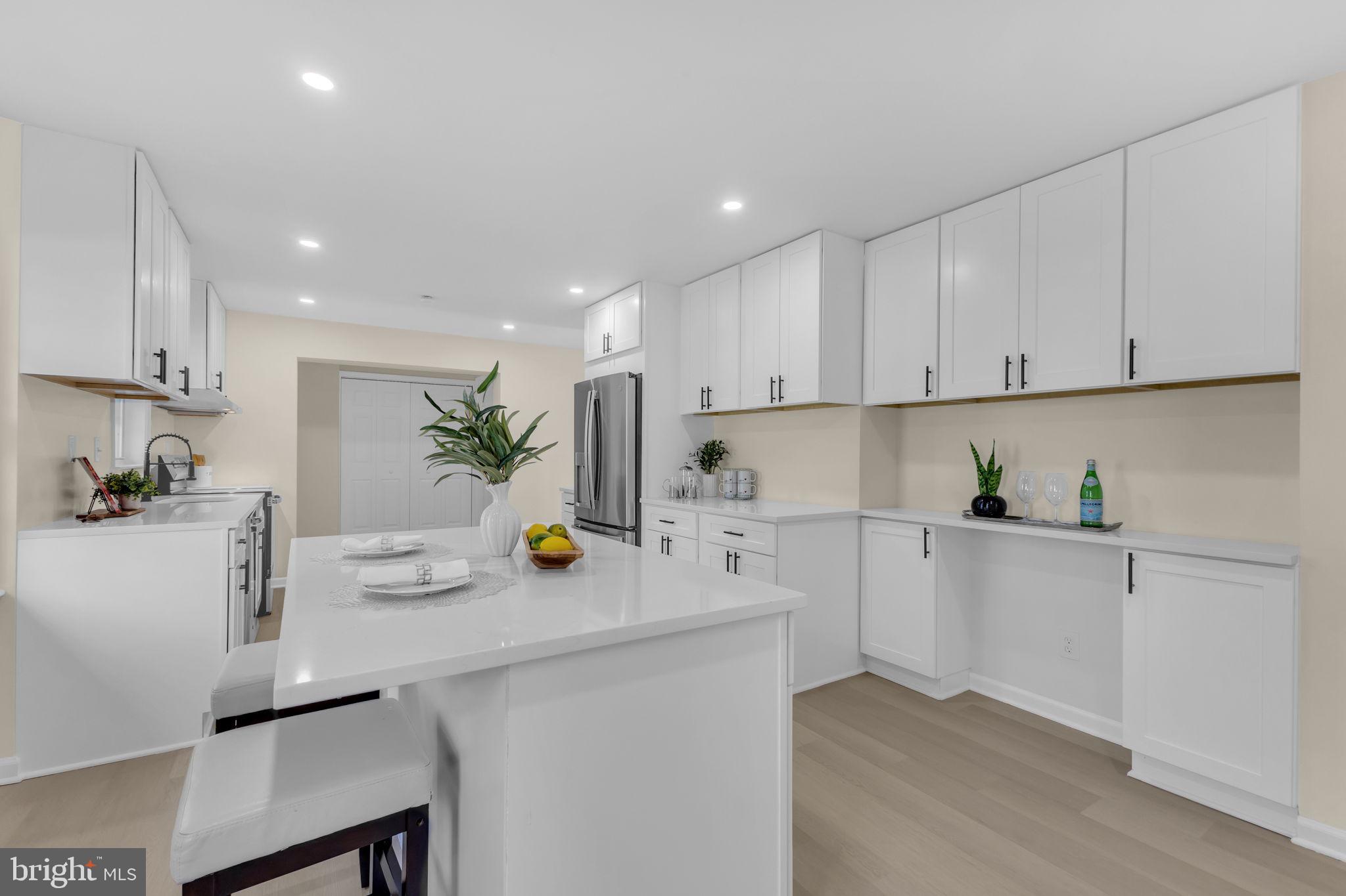 6400 Inwood Drive Springfield, VA 22150 - Photo 14 of 37 a kitchen with a sink white cabinets and white appliances