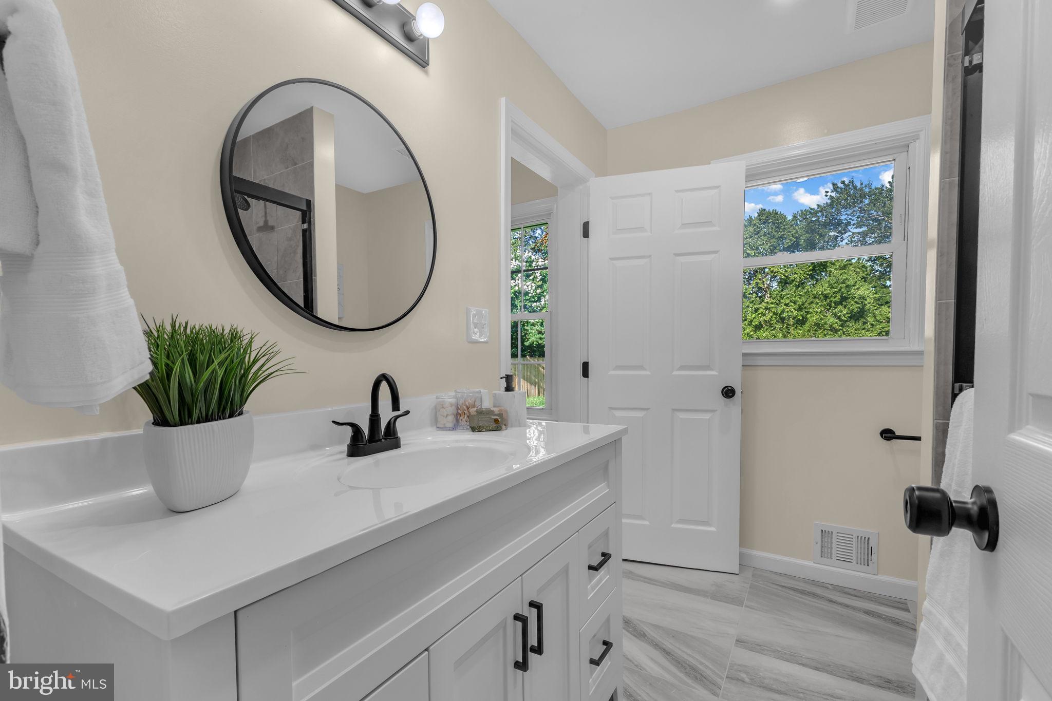 6400 Inwood Drive Springfield, VA 22150 - Photo 19 of 37 a bathroom with a sink and a mirror