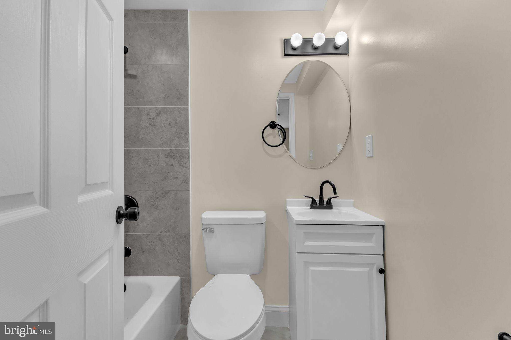 6400 Inwood Drive Springfield, VA 22150 - Photo 31 of 37 a bathroom with a toilet a sink and mirror