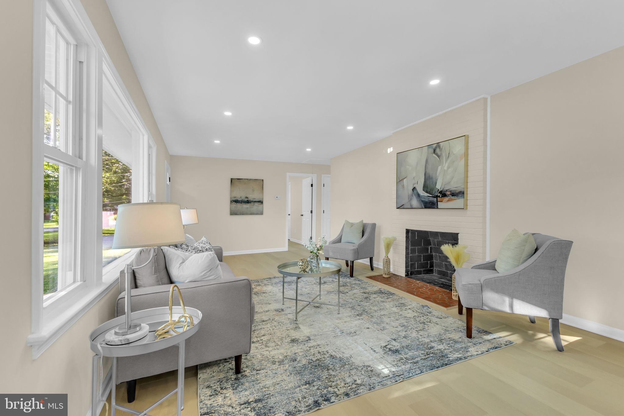 6400 Inwood Drive Springfield, VA 22150 - Photo 5 of 37 a living room with furniture and a fireplace
