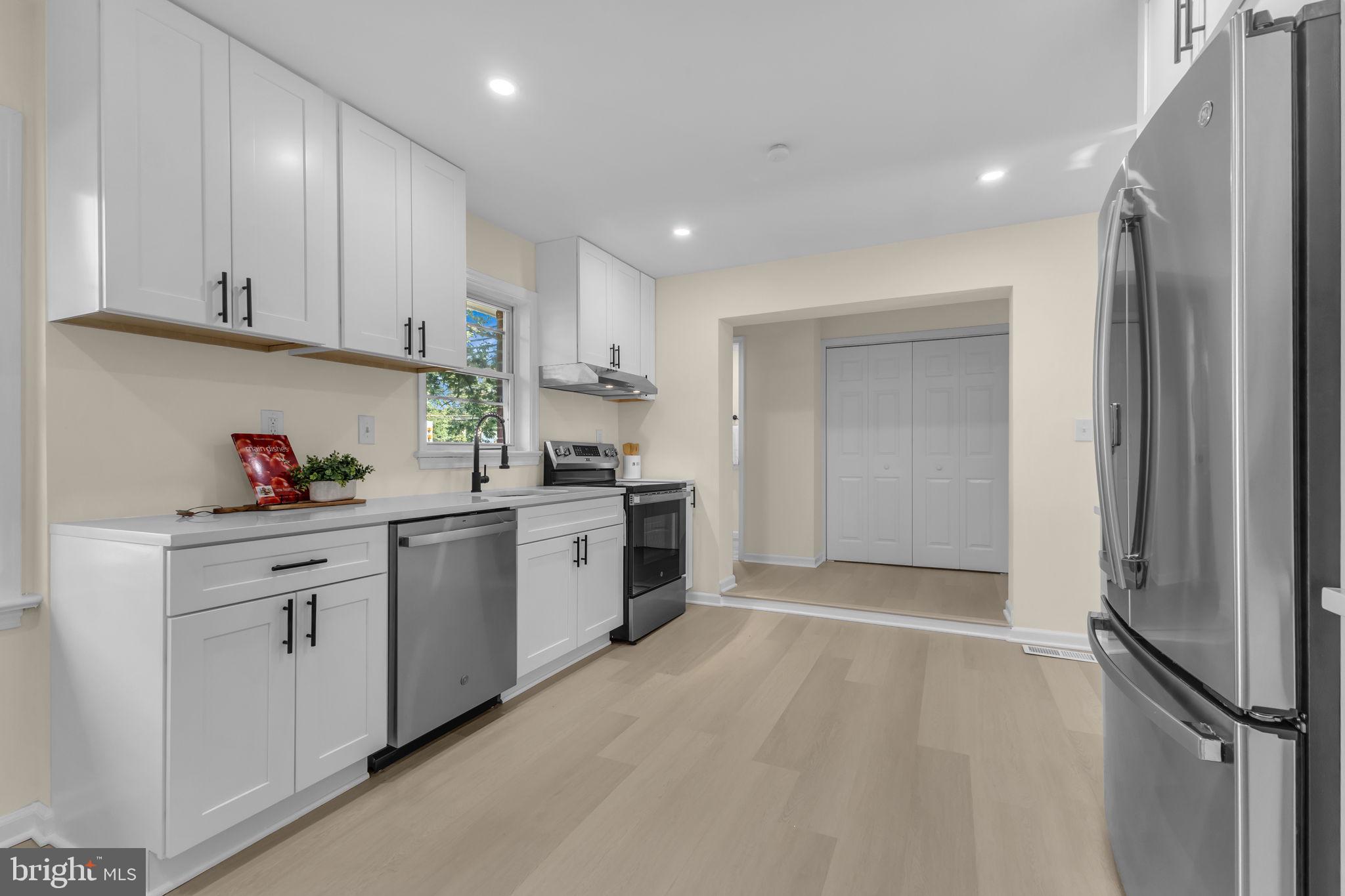 6400 Inwood Drive Springfield, VA 22150 - Photo 10 of 37 a kitchen with granite countertop a refrigerator stove top oven and sink