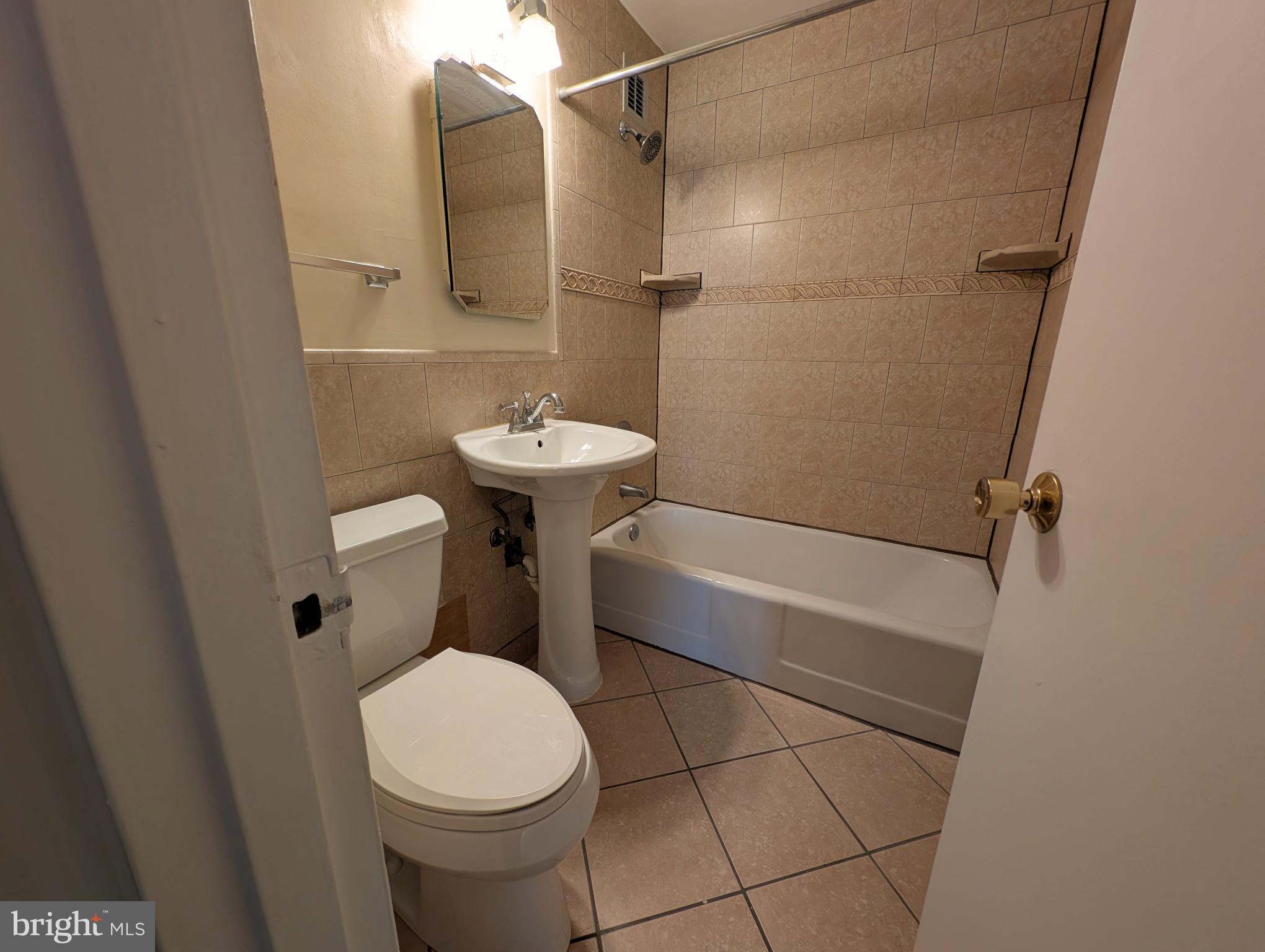 1121 Arlington Boulevard, Unit 218 Arlington, VA 22209 - Photo 13 of 32 a bathroom with a sink a toilet and shower