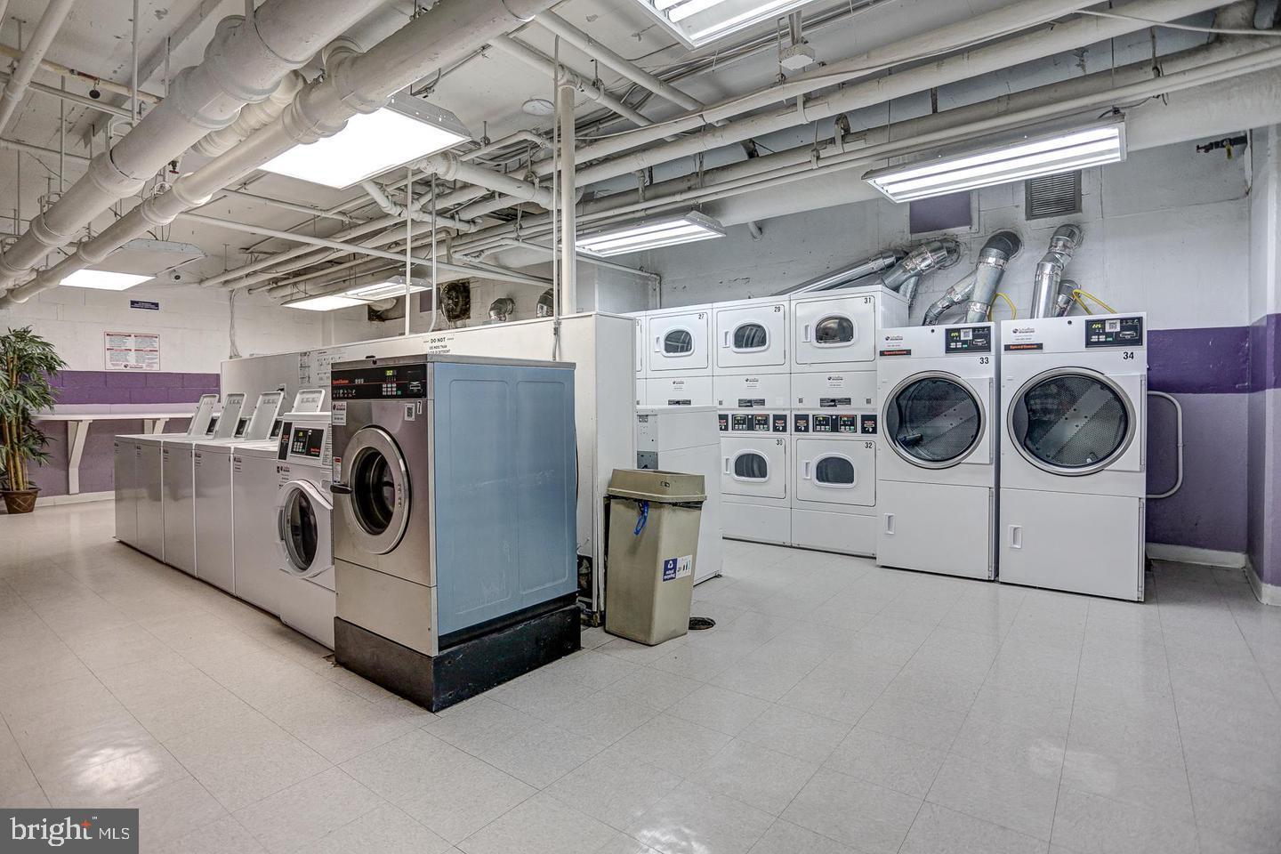 1121 Arlington Boulevard, Unit 218 Arlington, VA 22209 - Photo 20 of 32 a utility room with cabinets dryer and washer