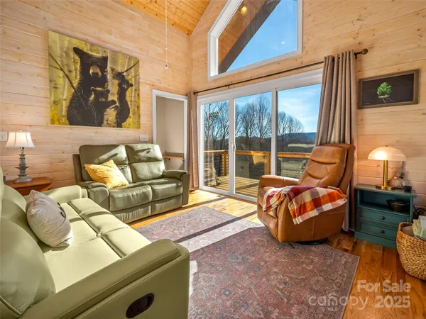 a living room with furniture and a floor to ceiling window