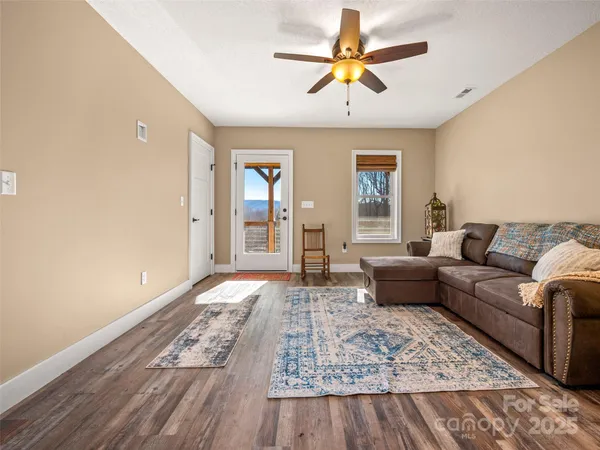 a living room with furniture and a wooden floor