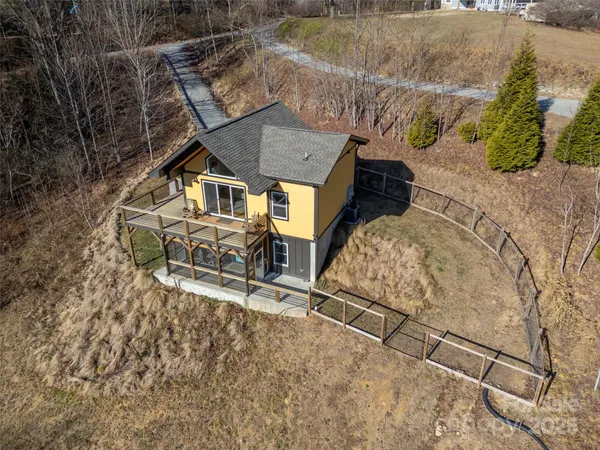 an aerial view of a house with a yard