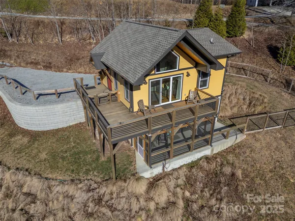 a view of a backyard with wooden fence