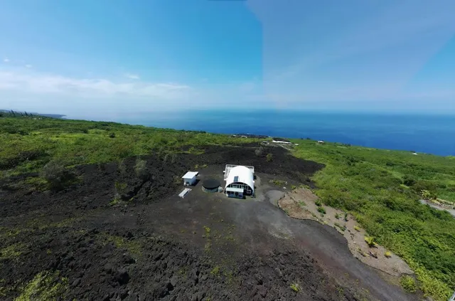 a view of a field with an ocean