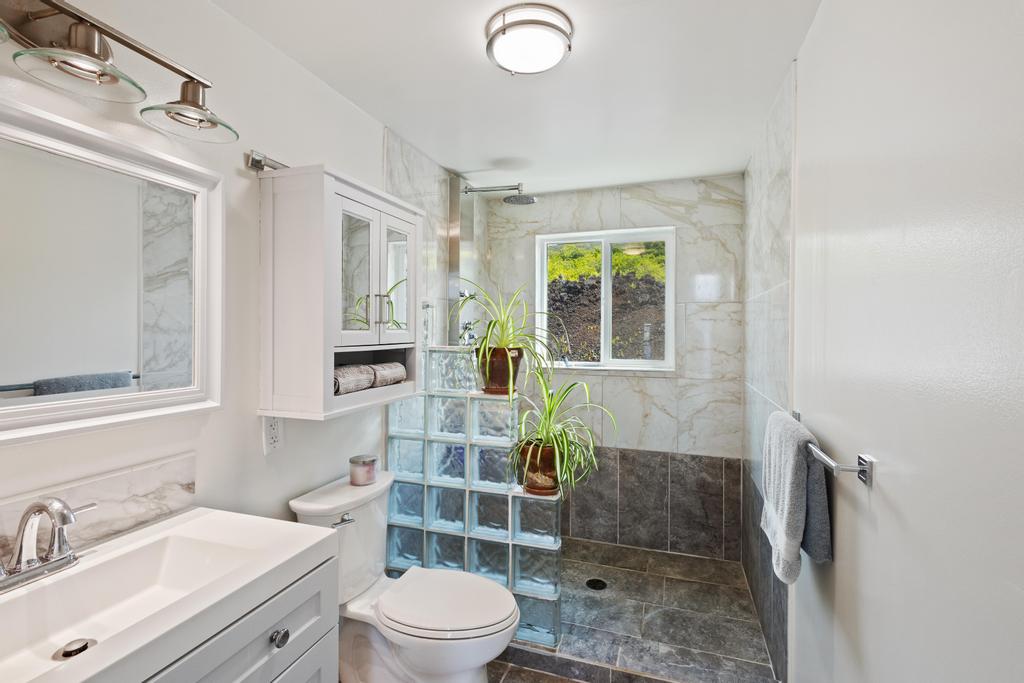 87-4521 Keahi Kai Place Captain Cook, HI 96704 - Photo 21 of 22 a bathroom with a sink toilet a mirror and shower