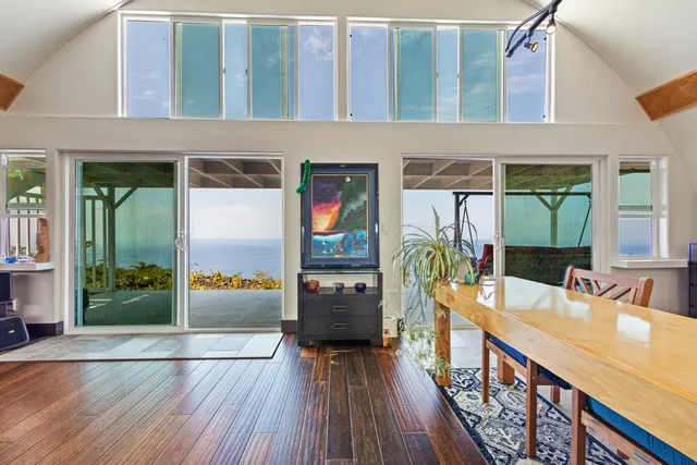 a view of a balcony with furniture and wooden floor