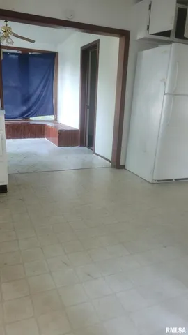 a view of a kitchen with a sink a window and cabinets