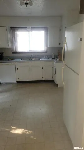 a view of room with a ceiling fan and window