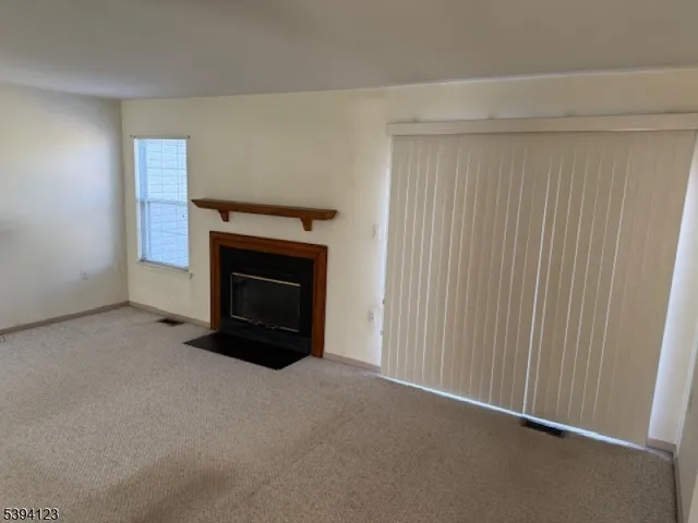 a view of empty room with a fireplace