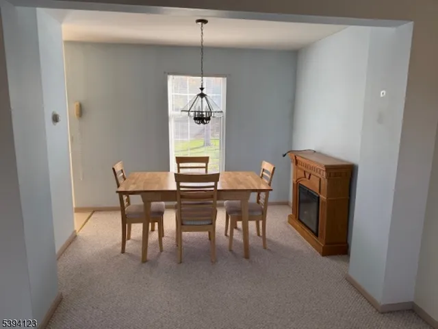 a dining room with furniture and chandelier