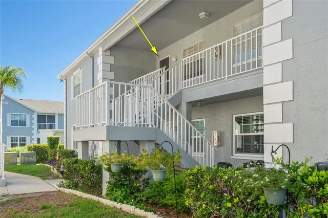 a view of a house with a small yard and plants