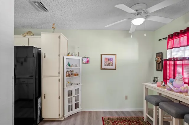 a room with furniture a chandelier fan and a window