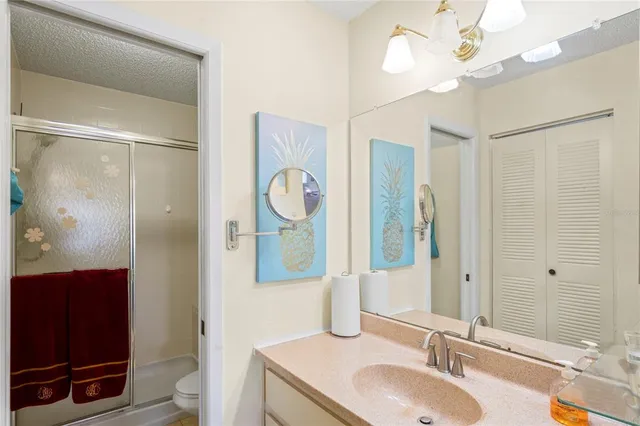 a bathroom with a sink a light fixture and a mirror