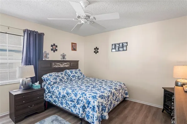 a bedroom with a bed and a lamp on dresser
