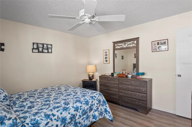 a bedroom with bed and wooden floor