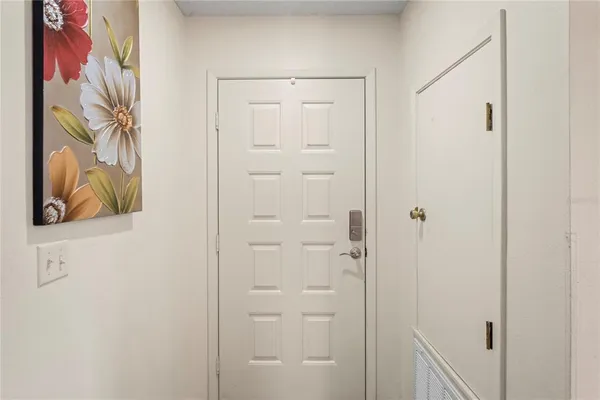 a bathroom with a painting on the wall