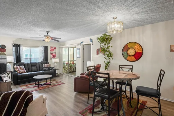 a living room with furniture a chandelier and a chandelier