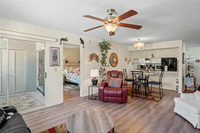 a living room with furniture and kitchen view