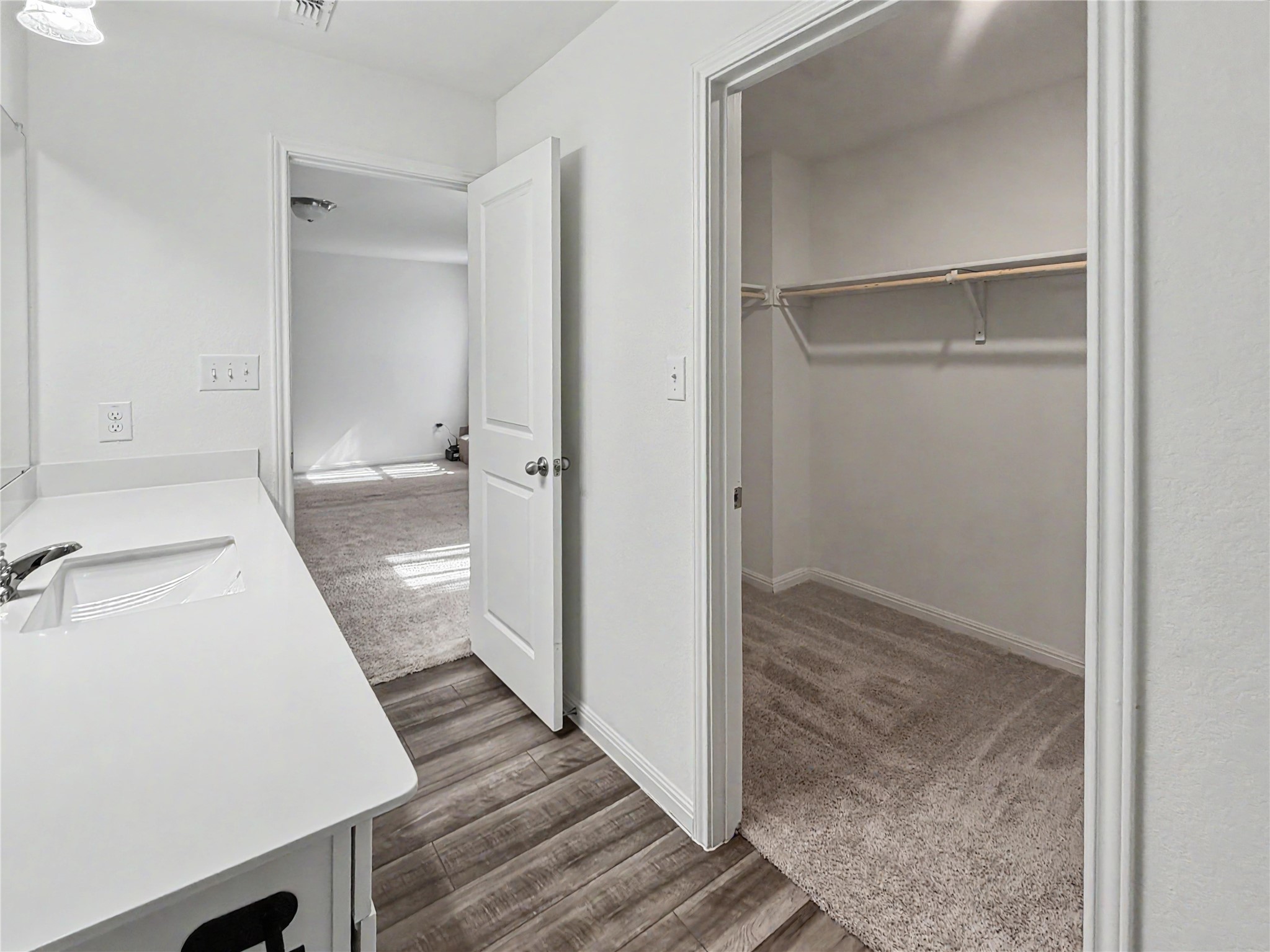 229 Night Riders Way Jarrell, TX 76537 - Photo 9 of 19 Smooth wood-look flooring transitions to soft carpeted spaces under bright, recessed illumination.
