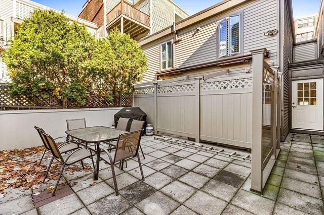 a view of a patio with table and chairs and potted plants