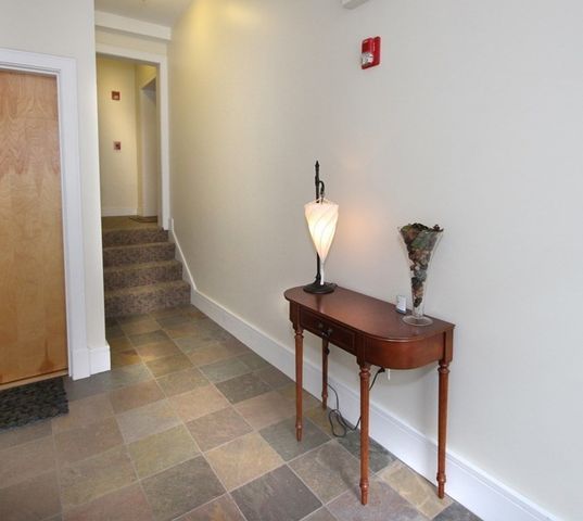 a view of a room with a sink and a mirror