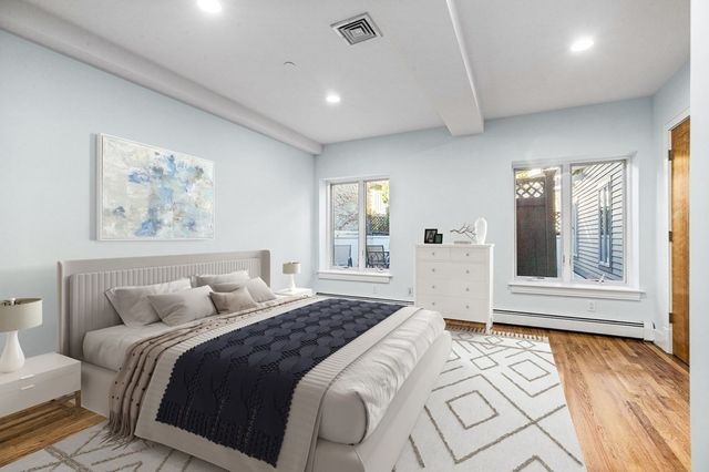 a bedroom with a large bed and a window