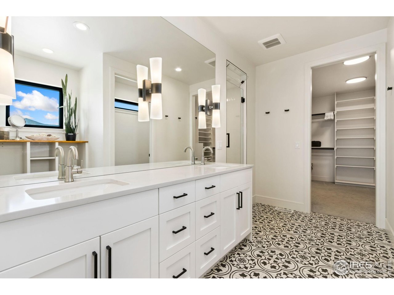 3802 Bridle Ridge Circle Severance, CO 80524 - Photo 20 of 50 a bathroom with a sink a mirror and a shower